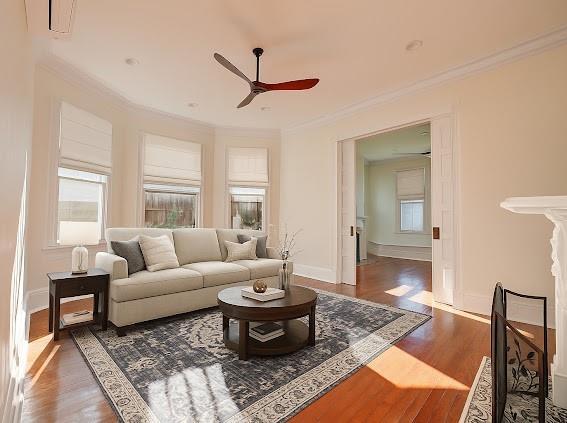 8241 Hickory St, New Orleans, LA 70118 - living area with a ceiling fan, plenty of natural light, crown molding, and wood finished floors