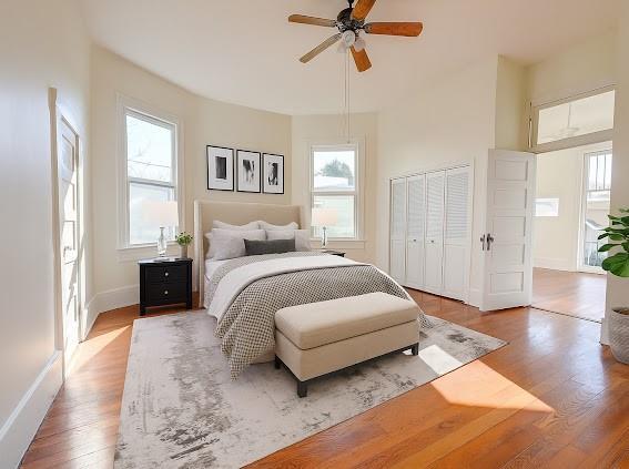8241 Hickory St, New Orleans, LA 70118 - bedroom with multiple windows, wood finished floors, and ceiling fan