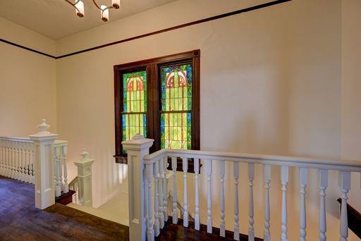 8241 Hickory St, New Orleans, LA 70118 - staircase with a chandelier and wood finished floors