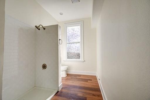 bathroom with walk in shower, lofted ceiling, toilet, and hardwood / wood-style floors