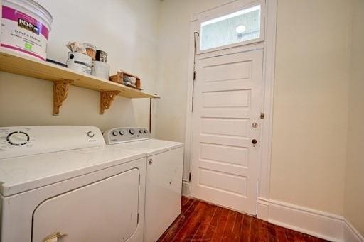 laundry area with washing machine and clothes dryer and dark hardwood / wood-style floors