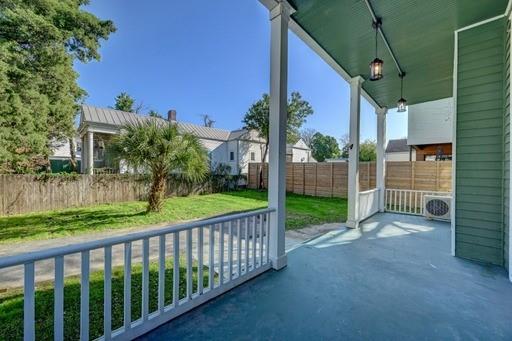 view of patio / terrace with ac unit and a porch