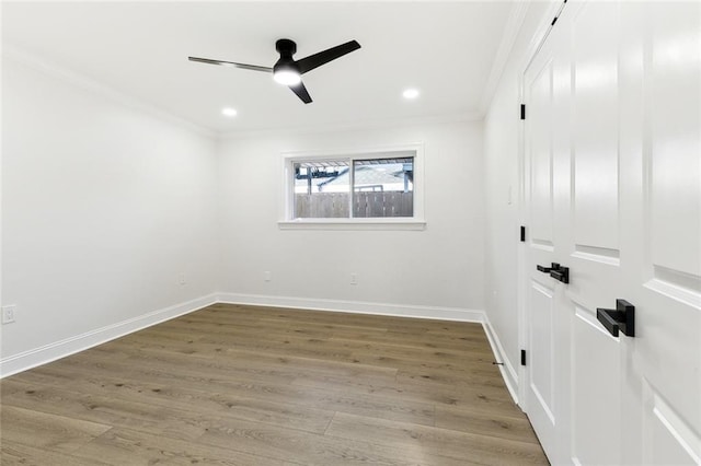 empty room with hardwood / wood-style floors, ceiling fan, and ornamental molding