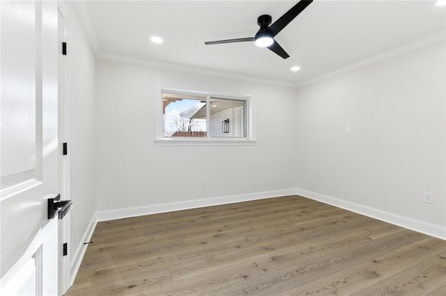 spare room featuring hardwood / wood-style floors, ceiling fan, and crown molding