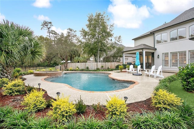 view of pool with an in ground hot tub and a patio