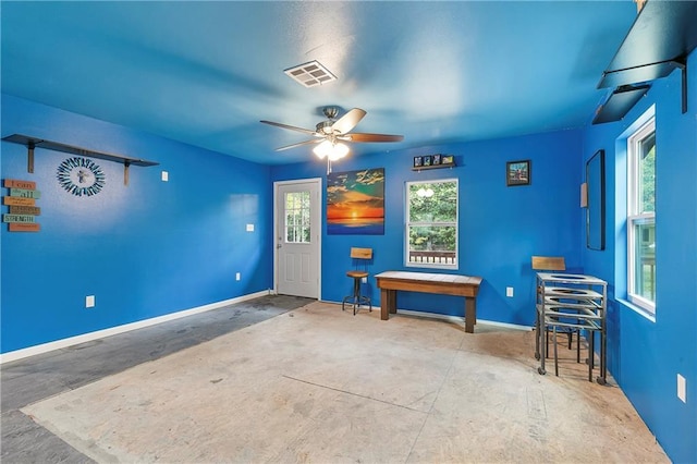 interior space with ceiling fan and concrete floors