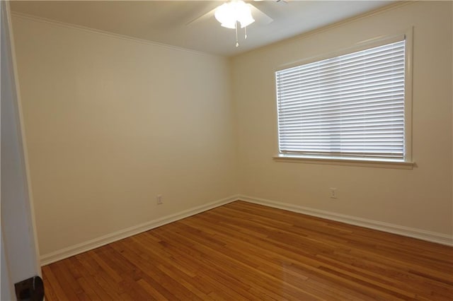 spare room featuring wood-type flooring, ceiling fan, and ornamental molding