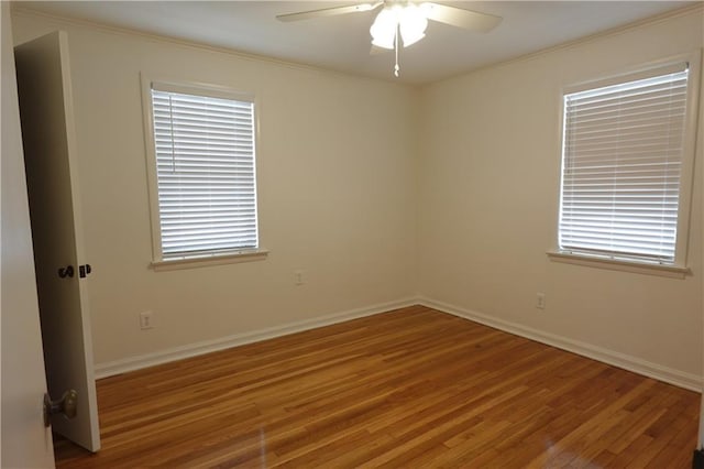 unfurnished room with hardwood / wood-style flooring, ceiling fan, and ornamental molding