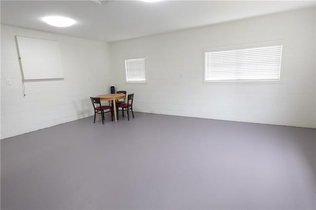 dining room with a healthy amount of sunlight and concrete flooring