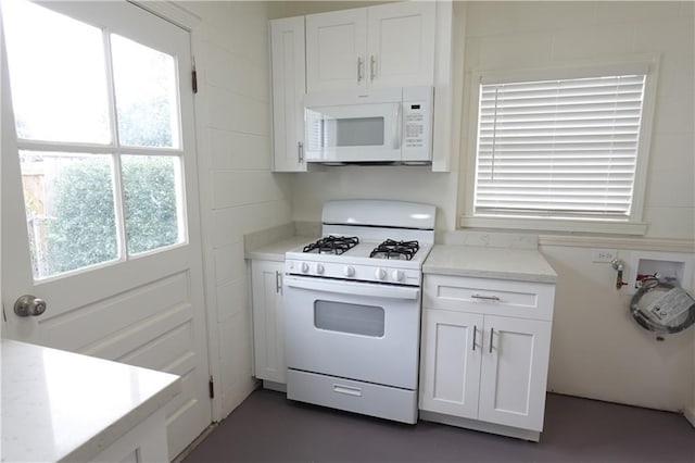 kitchen with white cabinets and white appliances