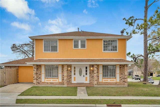 front facade with a porch and a front lawn