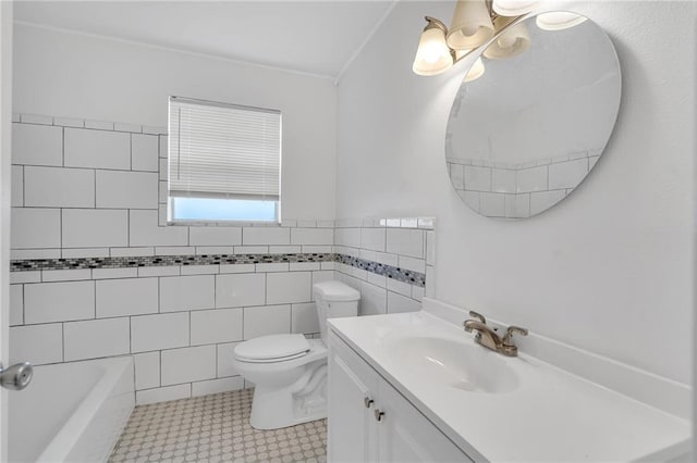 bathroom with vanity, toilet, and tile walls