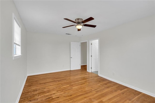 empty room featuring light wood-type flooring and ceiling fan