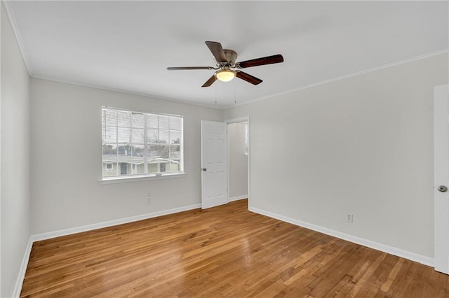 empty room with crown molding, ceiling fan, and wood-type flooring