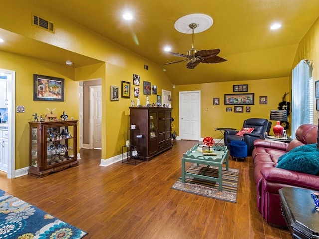 living room featuring ceiling fan, lofted ceiling, and wood-type flooring