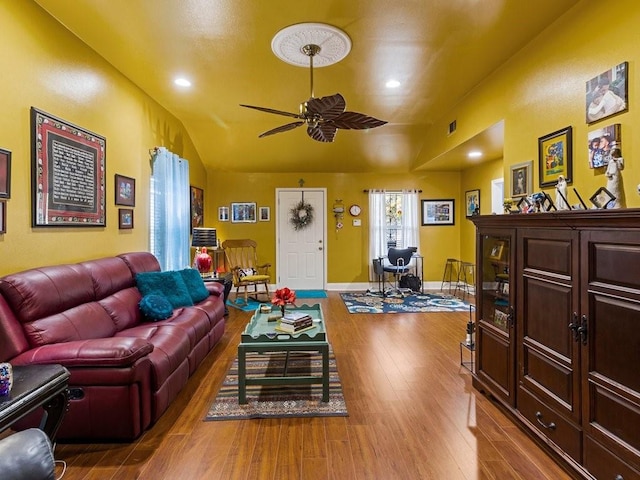 living room featuring vaulted ceiling, ceiling fan, and light hardwood / wood-style flooring