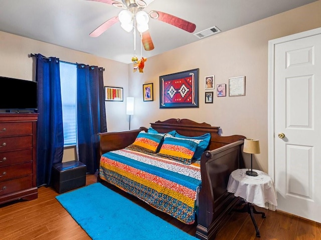 bedroom with hardwood / wood-style flooring and ceiling fan