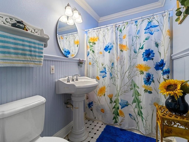 bathroom with toilet and crown molding