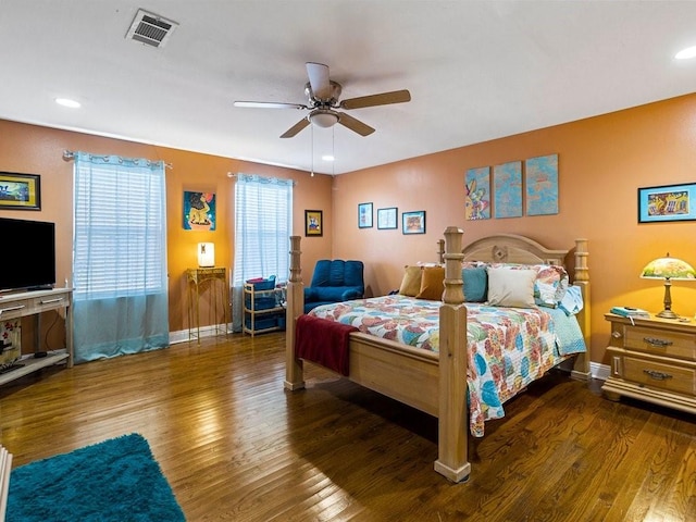 bedroom with ceiling fan, dark hardwood / wood-style floors, and multiple windows