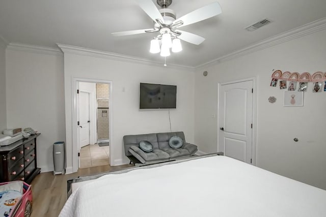 bedroom with ceiling fan, crown molding, and light hardwood / wood-style flooring