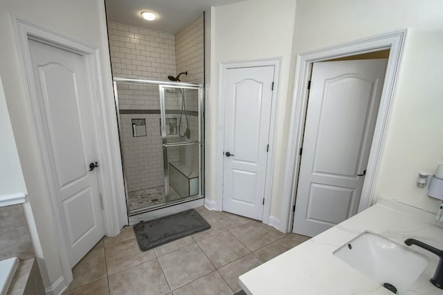 bathroom featuring tile patterned floors, vanity, and a shower with door