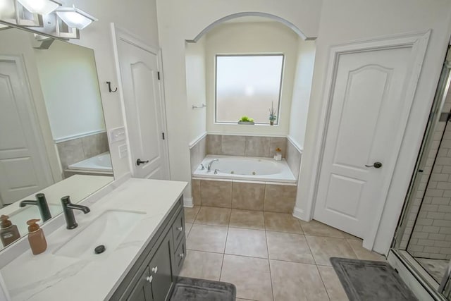 bathroom with tile patterned flooring, vanity, and independent shower and bath