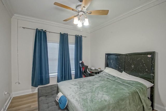 bedroom featuring hardwood / wood-style floors, ceiling fan, and ornamental molding