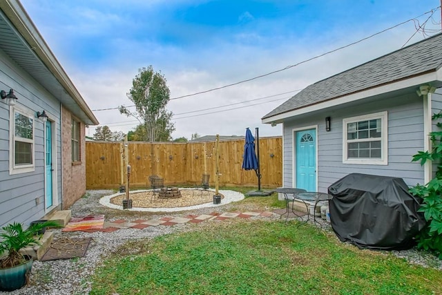 view of yard with an outdoor fire pit