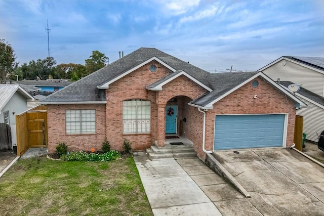 view of front of house with a garage and a front lawn