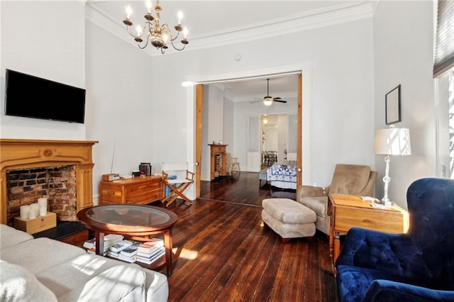 living room featuring ceiling fan with notable chandelier, dark hardwood / wood-style flooring, and crown molding