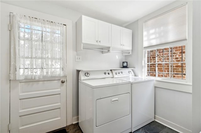 laundry room with washer and dryer, plenty of natural light, and cabinets