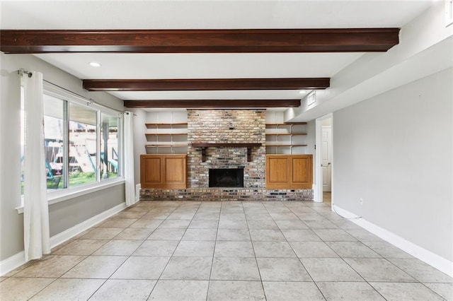 unfurnished living room with beamed ceiling, light tile patterned flooring, and a brick fireplace