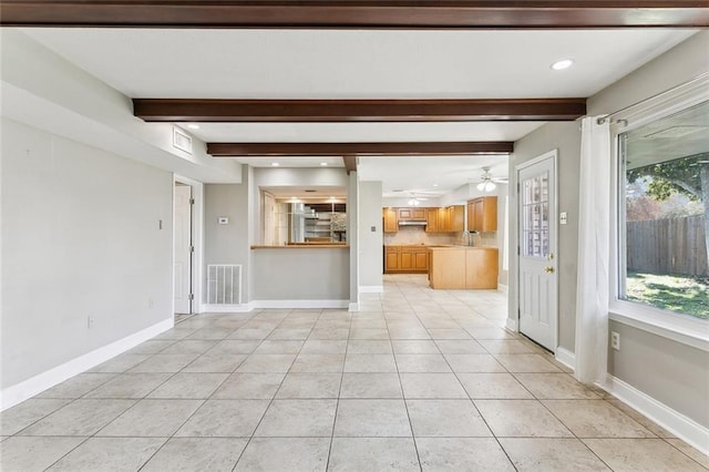 unfurnished living room with beamed ceiling, light tile patterned floors, and ceiling fan