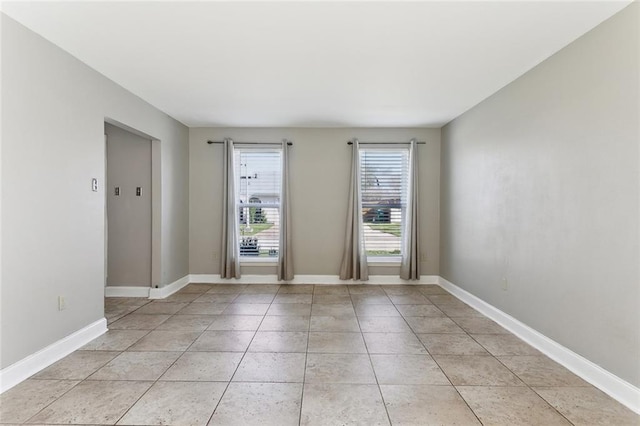 unfurnished room with light tile patterned floors