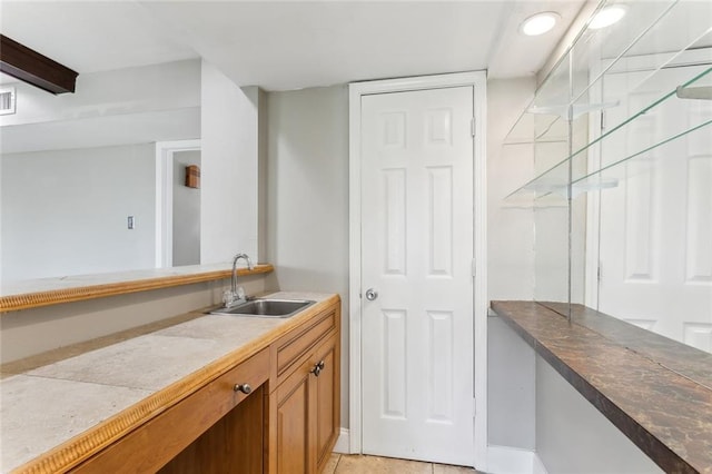 kitchen featuring tile counters, sink, and light tile patterned flooring