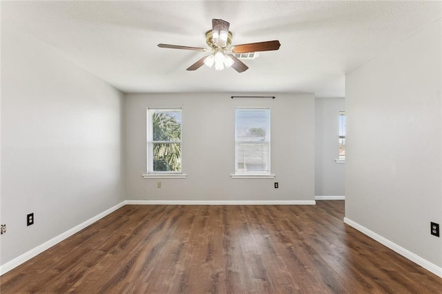 empty room with ceiling fan and dark hardwood / wood-style floors