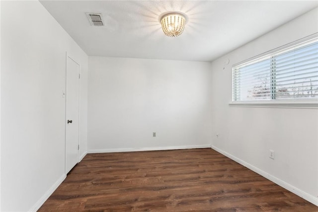 unfurnished room with dark hardwood / wood-style flooring