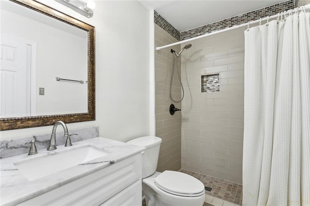 bathroom featuring a shower with shower curtain, vanity, and toilet