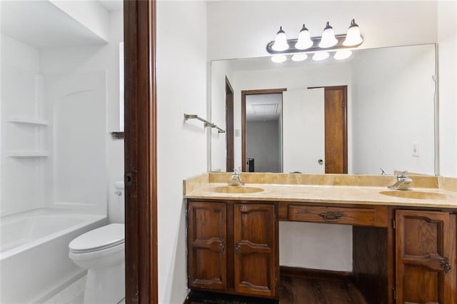 full bathroom featuring hardwood / wood-style floors, vanity, toilet, and bathtub / shower combination