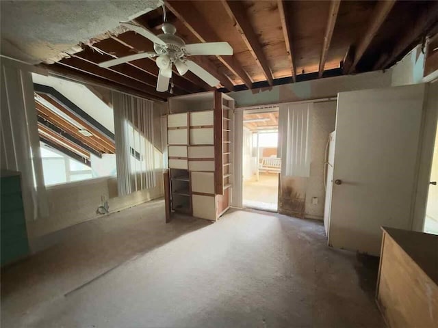 miscellaneous room with ceiling fan and concrete flooring