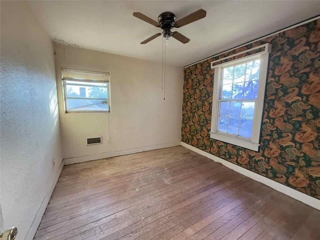 spare room with wood-type flooring and ceiling fan