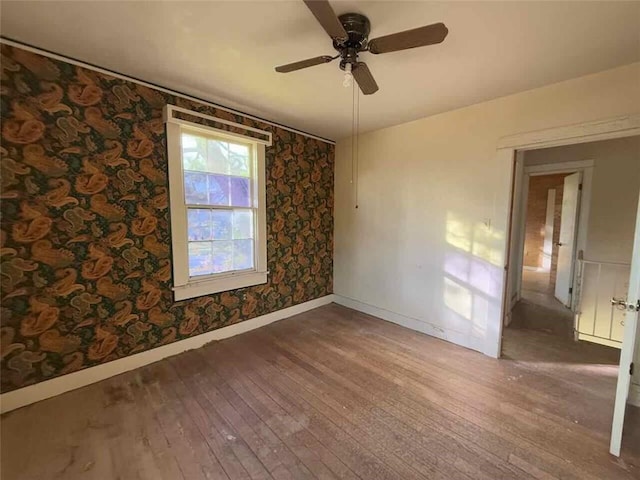 235 S Acadian Thruway, Baton Rouge, LA 70806 - spare room with wood-type flooring, a ceiling fan, and wallpapered walls