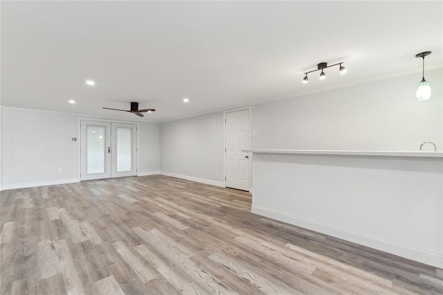 unfurnished living room with light hardwood / wood-style floors and ceiling fan