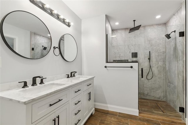 bathroom featuring a tile shower and vanity