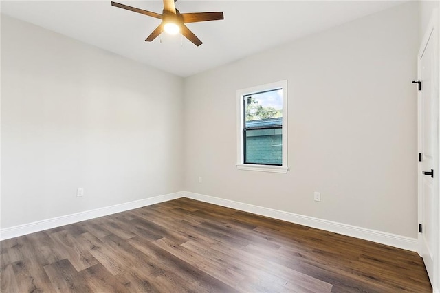 unfurnished room with ceiling fan and dark hardwood / wood-style floors