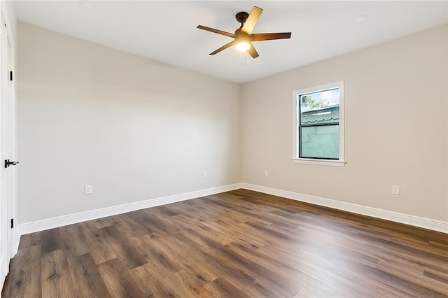 spare room featuring ceiling fan and dark wood-type flooring