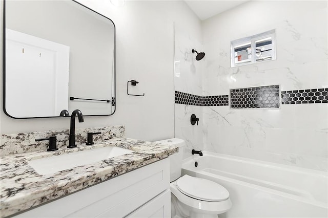 full bathroom featuring tiled shower / bath combo, vanity, and toilet