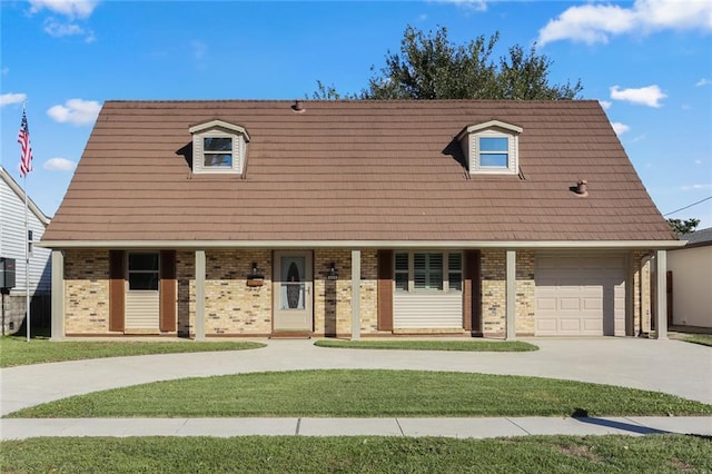 view of front of home with a garage, covered porch, and a front yard