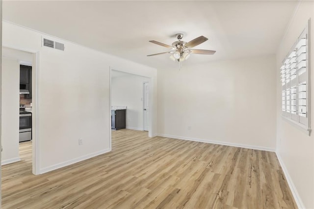 spare room with light hardwood / wood-style flooring and ceiling fan