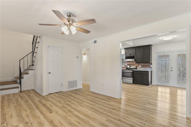 unfurnished living room featuring ceiling fan, french doors, and light hardwood / wood-style flooring